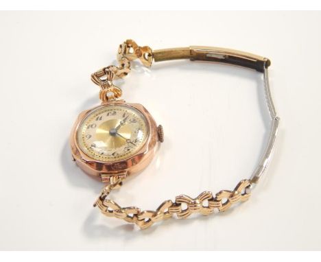 A early 20thC 9ct gold ladies wristwatch, having gilt separated chapter ring dial, Arabic numerals and blue brocade hands on 