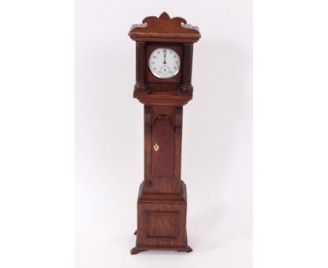 19th century oak pocket watch holder in the form of an oak miniature longcase clock, housing contemporary silver plated pocke