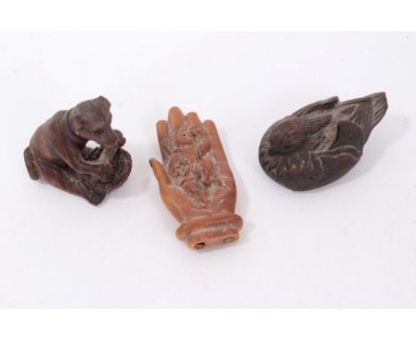 Three Japanese carved wooden netsukes, including carving of a duck, 5cm long, another in the form of a dog with a basket and 
