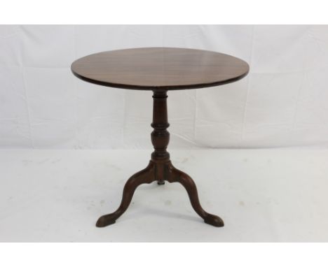 George III mahogany tripod table, circular tilt top on turned vase shaped column and tripod cabriole base with pad feet, 72cm