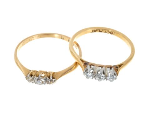 Two 18ct gold diamond three stone rings, each with three round brilliant cut diamonds in claw setting on 18ct gold shanks (2)