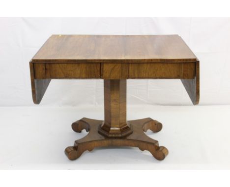 Regency rosewood sofa table, having rounded rectangular drop-leaf top and two frieze drawers with beaded ornament, raised on 