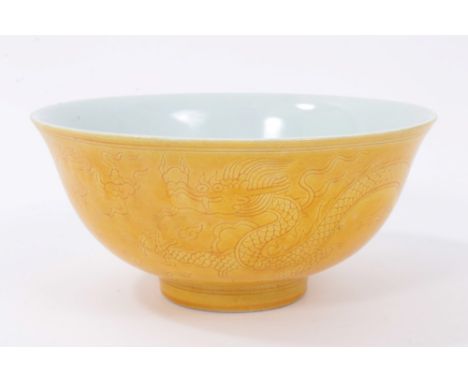 Chinese yellow-glazed monochrome porcelain bowl, with incised decoration showing dragons chasing a flaming pearl, spurious Ch