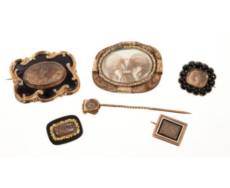 Collection of antique mourning jewellery to include five brooches and a stick pin (6)