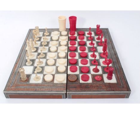 Collection of 19th century ivory and stained ivory chess and draughts pieces, the tallest 9cm and two dice shakers, housed wi