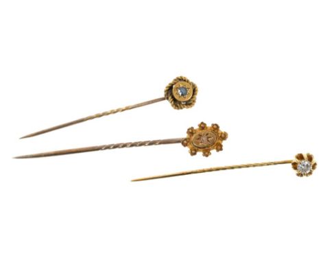 Three stick pins to include a diamond stick pin with a brilliant cut diamond estimated to weigh approximately 0.20cts, togeth