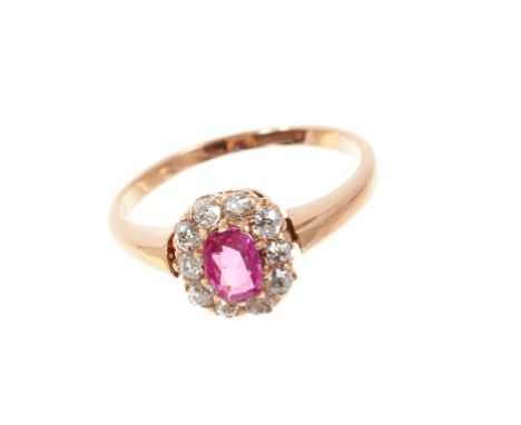 Late Victorian ruby and diamond cluster ring with a mixed cut ruby weighing approximately 0.31cts surrounded by ten old cut d