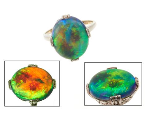 Opal single stone ring with an oval cabochon opal measuring approximately 14mm x 12mm in claw setting. Finger size L.