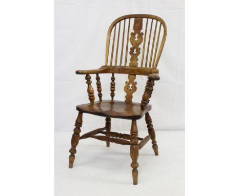 Victorian ash and elm Windsor stick back elbow chair, high arched back with pierced fret carved splat and saddle seat on ring