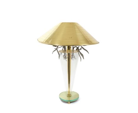 1970s brass and glass lamp, with broad gilt shade, on everted conical form with metal tendril ornament on mirrored base, 74cm