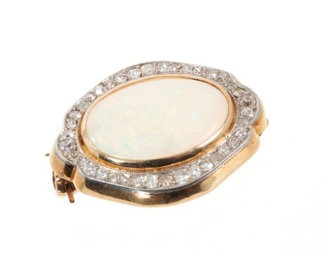 Opal and diamond brooch with an oval opal cabochon measuring approximately 17.4 x 12mm surrounded by a border of old cut diam