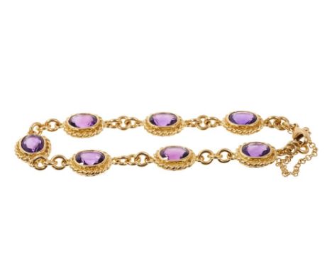 18ct gold and amethyst bracelet with seven oval mixed cut amethyst in gold rub-over setting with rope twist borders. 20cm len