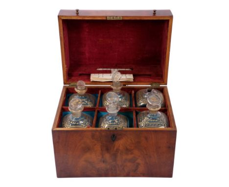 Late 18th/early 19th century Continental mahogany decanter box, the flame veneered domed case enclosing six hand-blown decant