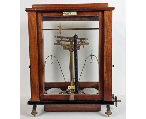 A set of early 20th century balance scales by Oertling (model number 48G.C.) in a mahogany case. H.48 W.37 D.27cm. 