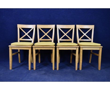 A set of four Continental style light oak dining chairs. 