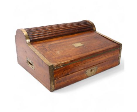 A 19th century brass-bound camphorwood military writing slope, brass edges and recessed carrying handles, with tambour top se