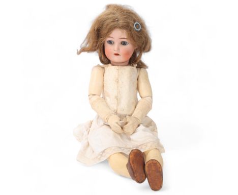 A bisque porcelain-headed girl doll, made by Kammer & Reinhardt using Simon & Halbig bisque head, no. 58. length 61cm 