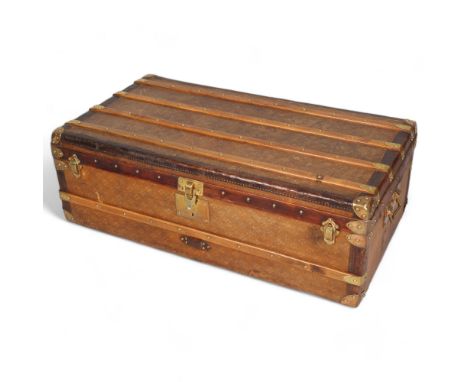 A Vintage French travelling trunk, brass wood and leather-bound with canvas panels, original label inside for E Deraisme Pari