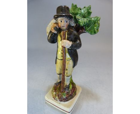 Staffordshire Pearlware figure of a Shepherd, possibly Walton. C.1800 - 1820. The man decorated in ochre and brown holding a 