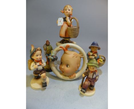 Selection of Goebel Hummel figures along with a Circular wall plaque depicting a baby looking at a bee impressed M J Hummel. 