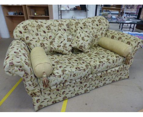 Floral upholstered beige ground three seater sofa