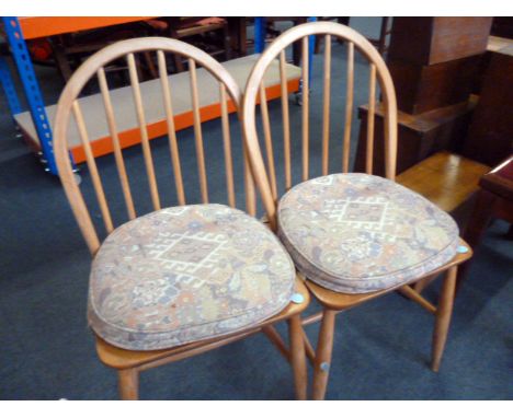 A set of four Ercol chairs, having added pattern cushions (4)