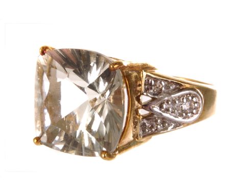 A 9ct gold and green quartz dress ring, the mixed cut interesting green stone in high mounted single claw mount, with clear s