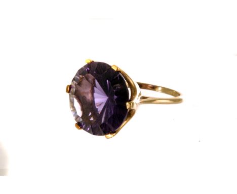 A 9ct gold and colour change Alexandrite dress ring, the large round cut stone set in 9ct gold mount, size O, approx 6.9g