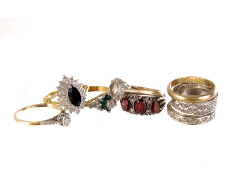 A collection of gold and silver gem set rings, including a yellow metal band, three red stone silver ring, 9ct gold and illus