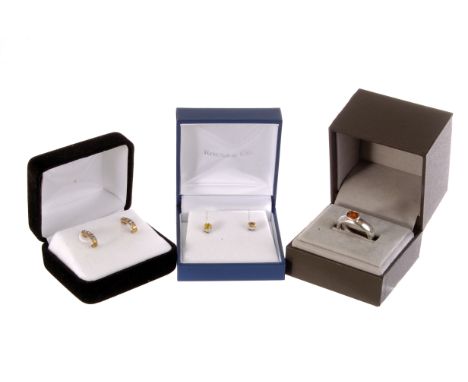 A silver and gem set ring, the orange oval cut stone set in hallmarked silver, size N, together with two pairs of gem set ear
