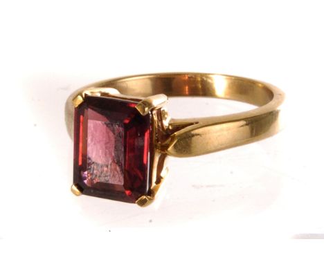 A 9ct gold and garnet dress ring, the step cut garnet mounted in 9ct gold single claw mount, size N, approx 3.6g