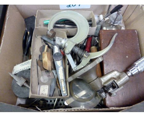 A quantity of watch makers tools, including clamps, miniature anvil, hand tools, stock and die set, brooches and more (parcel