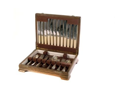 A 1930s oak canteen of silver plated flatware, comprising table spoons, tea spoons, knives and forks (parcel)