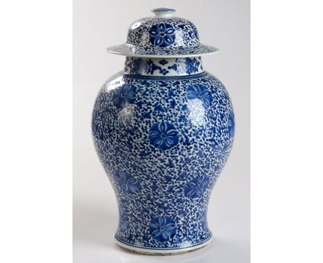 Of baluster form, the neck painted with a flower roundel and diamond lozenge pattern, the body boldly painted with blue ‘flow