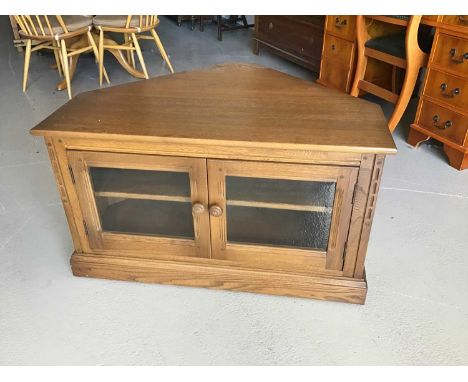 Ercol corner television cabinet/stand with two glazed doors below enclosing one adjustable shelf H55cm W96cm D73cm