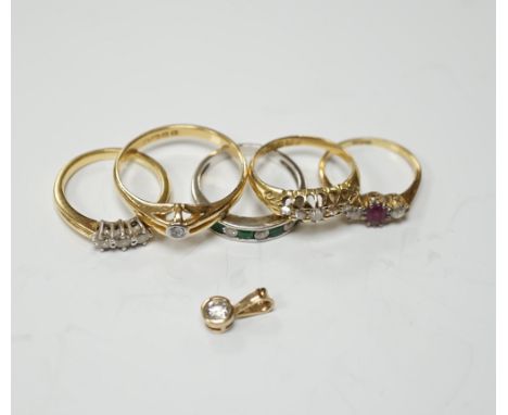 Four assorted early 20th century and later 18ct and gem set rings, including solitaire diamond and three stone diamond, gross