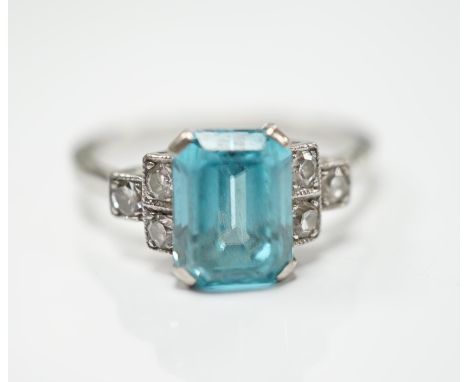 An 18ct, plat and single stone emerald cut blue zircon set ring, with six stone diamond set shoulders, size L, gross weight 2