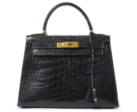 A vintage Hermès 28 Kelly in black alligator with gilt metalware, the bag has a square symbol near the embossed Hermes logo a