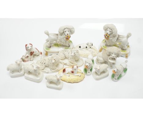Two Samuel Alcock models of recumbent spaniels, a Staffordshire porcelain model of a seated spaniel and six similar sheep c.1
