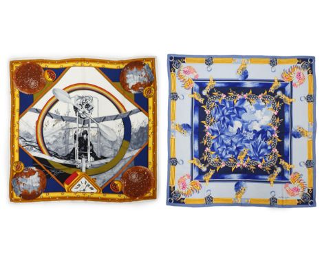 A Must de Cartier vintage silk scarf with owls in sapphire and a Must de Cartier silk scarf with figure clock pattern, 87cm x