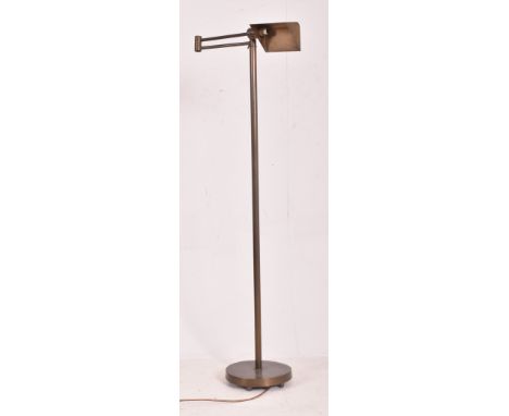 A Contemporary High End Design brassed metal articulated floor standard lamp. The lamp with shaped brassed metal shade over a