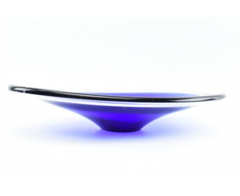 A vintage mid century oval shaped blue glass cased bowl in the style of Murano. The bowl with swept form, cased cobalt glass.