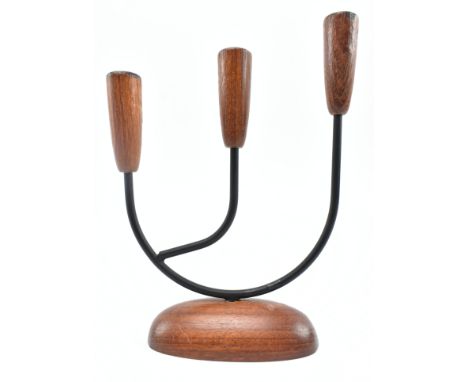 A retro 20th century Danish design candlestick holder. The candlestick having three turned teak holder tops supported by meta