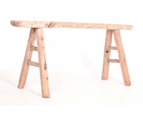 A vintage 20th century rustic reclaimed elm pig bench seat. Having peg joint angled feet united by stretcher with plank top.M