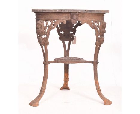 A Victorian 19th centuty cast iron &amp; hardwood garden pub side table. The table having a circular wooden top over moulded 