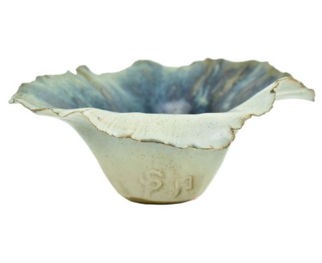 A studio art pottery glazed ceramic vase. The vase having a flared napkin-style rim with blue tones on grey ground. Stamped w