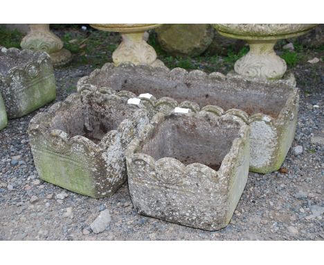 An oblong planter and two smaller square planters all with scalloped edging