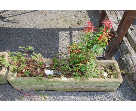 A concrete planter, 36" long.