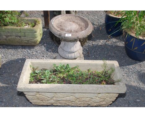 A concrete bird bath, 18" tall, 12" diameter top together with long concrete planter.
