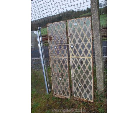 A pair of cast iron diamond panel windows, (bottom opening), 55" high.